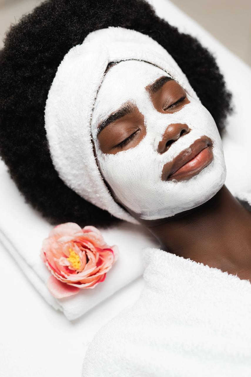 Soft luxury skincare setting with sage and white tones